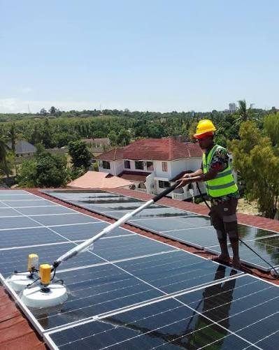 Technician cleaning a commercial rooftop array in Matara